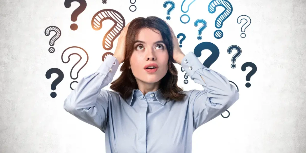 What Is The Difference Between A Head Spa And A Treatment? 2 A Confused Woman With Her Hands On Her Head Looks Upwards, Surrounded By Multiple Question Marks Of Various Sizes And Styles Floating Above Her