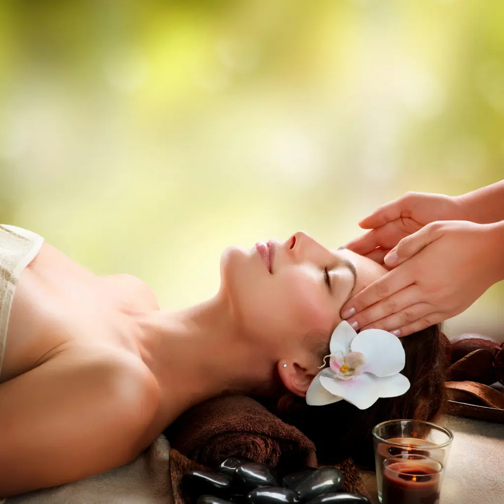 Hands massaging a person's head.