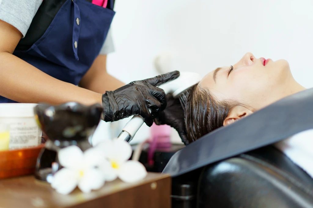A woman receiving a relaxing head spa treatment