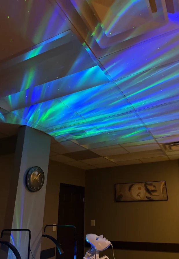Relaxing Northern Lights Ambient Projector Lighting On A Spa Room Ceiling.