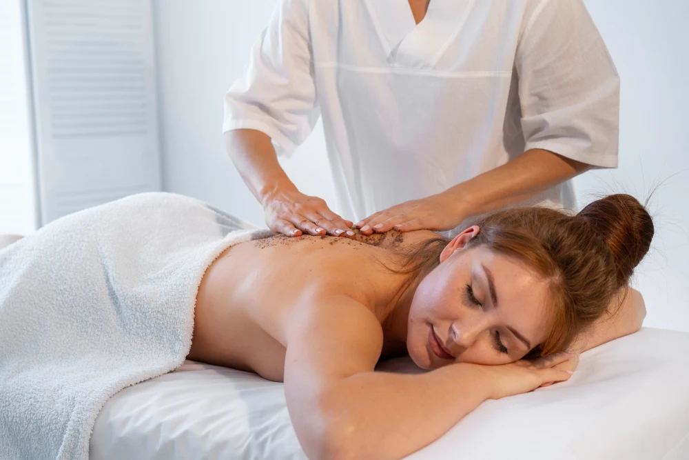 Woman Receiving A Relaxing Lymphatic Drainage Massage And Body Scrub At A Day Spa.