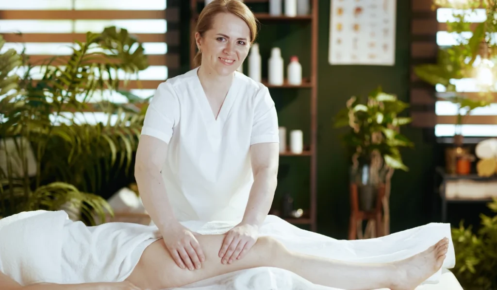 Massage For Stress Relief: A Simple Guide To Calming Your Mind And Body 4 A Professional Therapist Massaging A Client'S Leg On A Spa Table, Helping To Improve Circulation And Reduce Physical Stress.